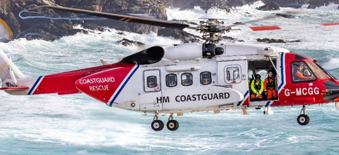 Coastguard helicopter hovers over the sea. 
