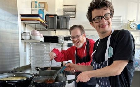 Two people standing next to a sign that reads "Bemix pop up"