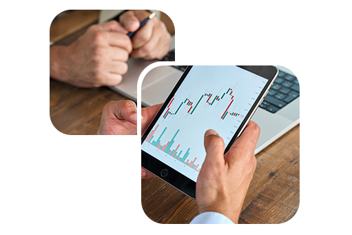 Two sets of hands resting on top of a desk with one set of hands holding a tablet displaying a data graph.