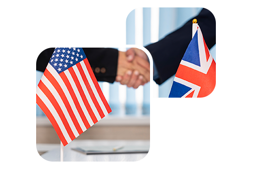 A handshake in front of the Union Jack and American flag.