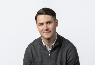 A professional headshot of Jake Beavis.