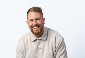 A professional headshot of Louis Spencer.