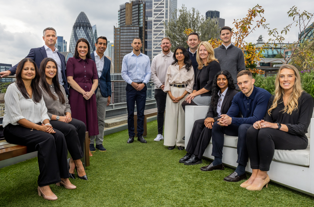 The Ventures team standing in front of the London skyline.