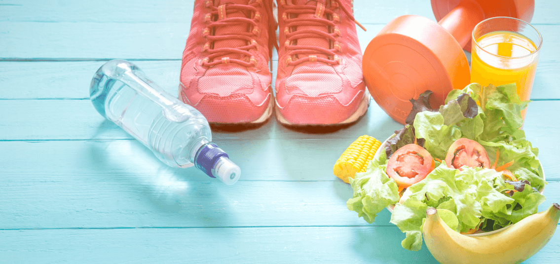 photo of brightly coloured products on a blue floor, including fruit, veg, soft drinks and sports shoes