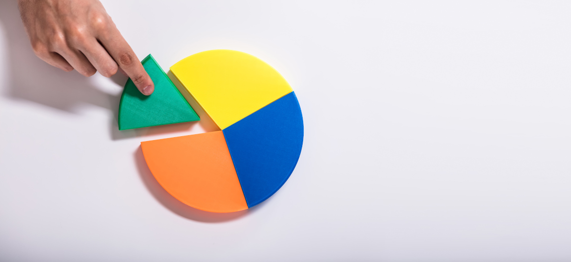 Photo of a hand taking a green slice out of a multicoloured pie chart
