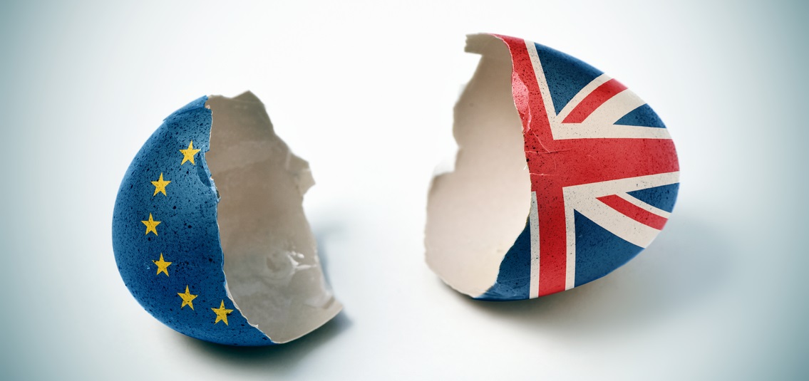 an eggshell, broken in two - one half painted with EU flag and the other with UK flag