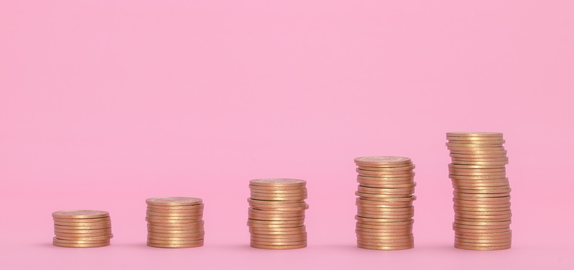 stacks of coins with a pink background