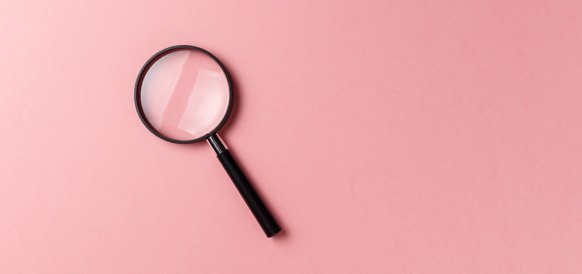 magnifying glass on colour background