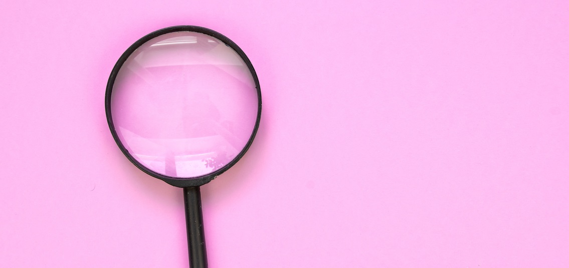 magnifying glass on pink background