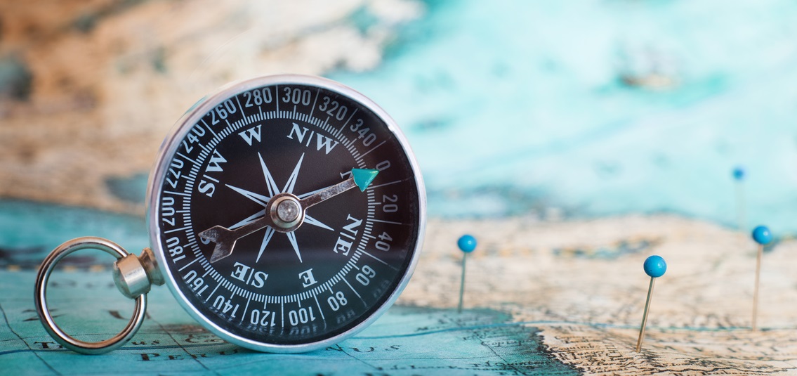 photo of a map and magnetic compass
