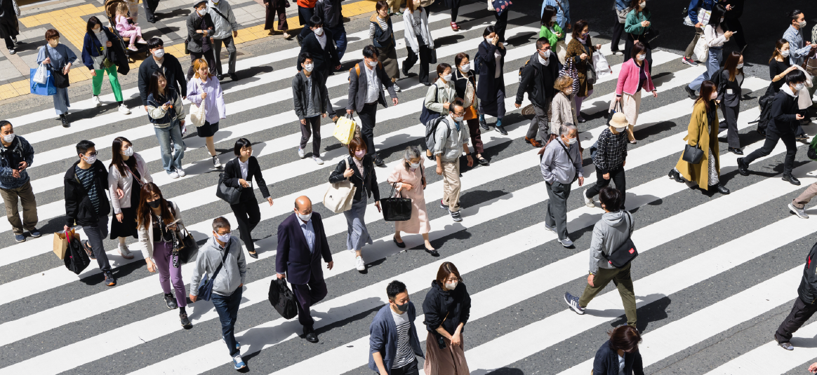 People in Japan walking over a zebra crossing