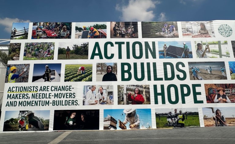 ‘Action builds hope’ signage at UAE COP28.