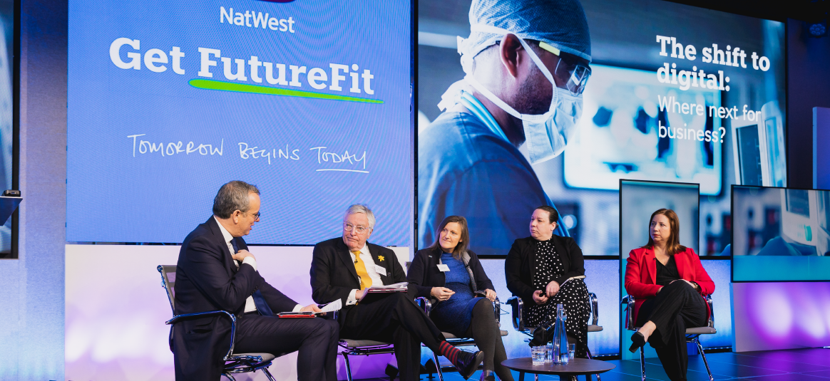Photo of Get FutureFit event with five speakers on stage