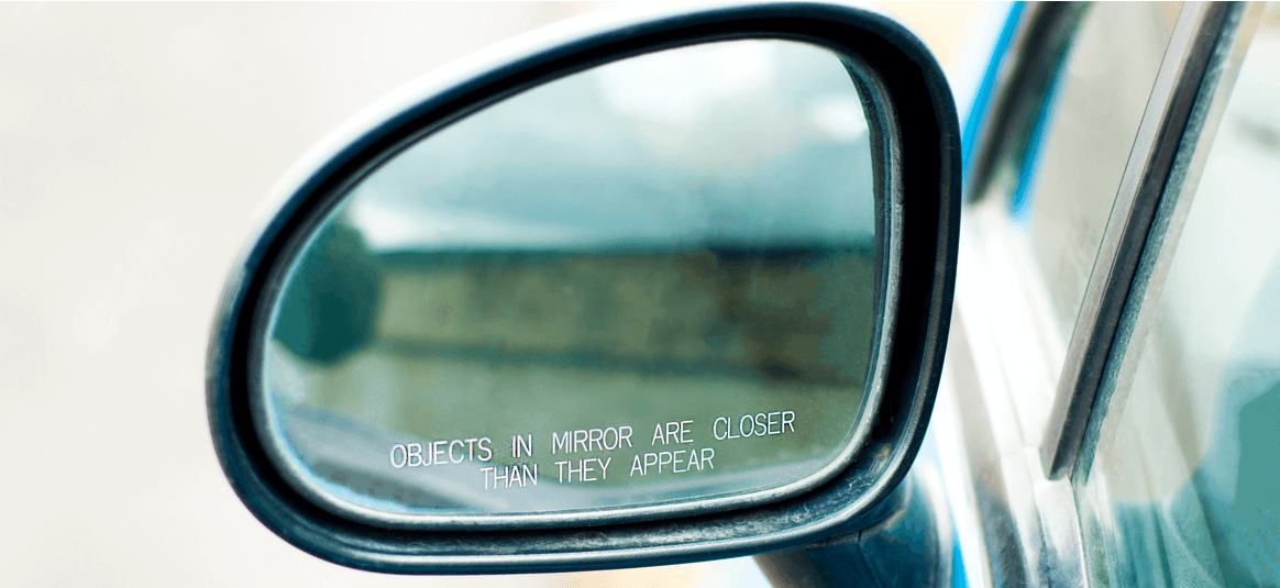 Car mirror with text - objects in the mirror are closer than they appear