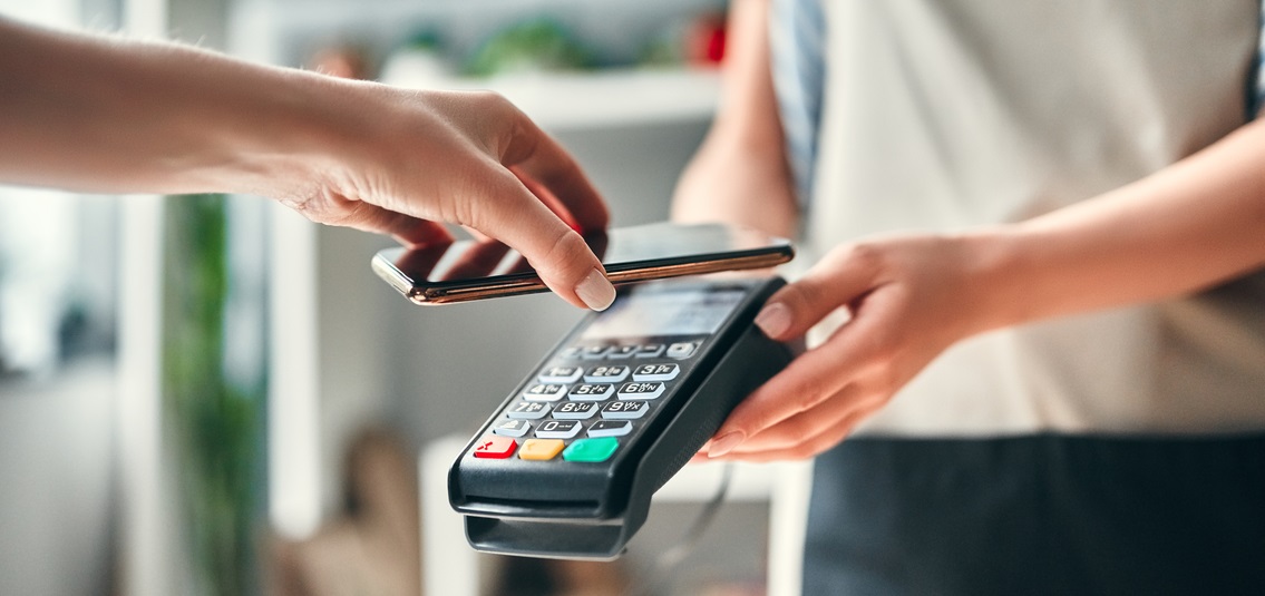 Close up of hand paying with a contactless card