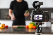 Photo of a video camera in front of a chef