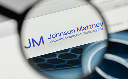 Photo of a magnifying glass on a screen showing the Johnson Matthey logo