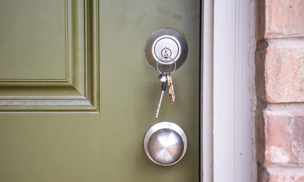 Photo of a bunch of keys in a front door lock
