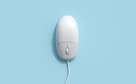White computer mouse on a blue surface