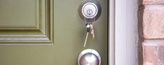 Photo of a bunch of keys in a front door lock