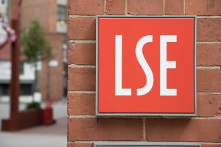 LSE wall-mounted sign, white letters on a red square background.