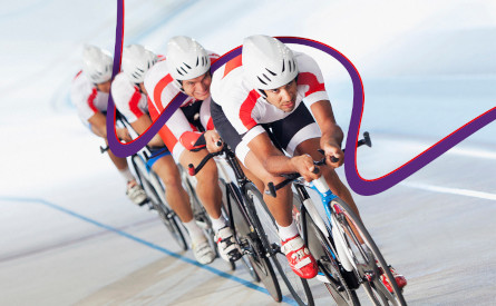 Photo of four racing cyclists and a meandering purple line