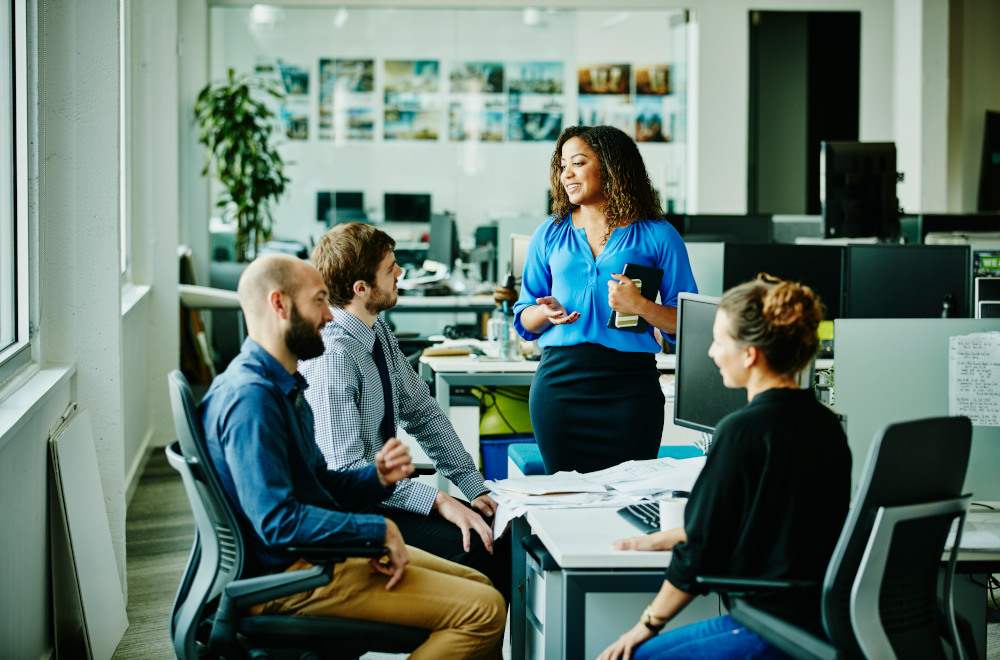 Professionals having a meeting in a modern looking office environment.