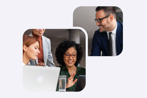 People in an office looking at a laptop on a desk.