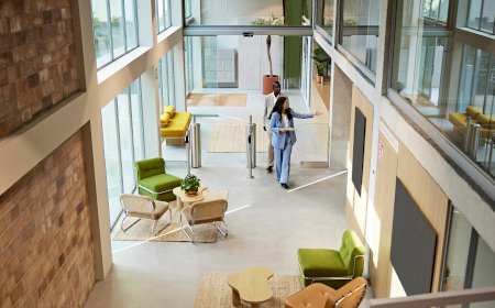Woman entering a building through the main entrance.