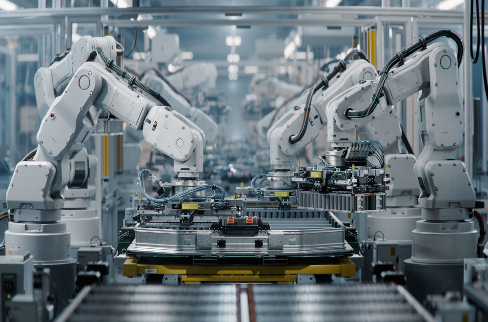 Robot arms assembling metal parts in a factory.