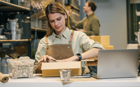 Artisan shop staff wrapping a box in a retail setting