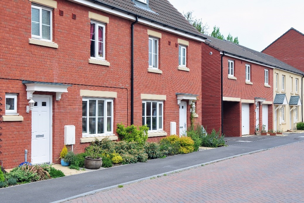 A row of red-brick terraced houses.