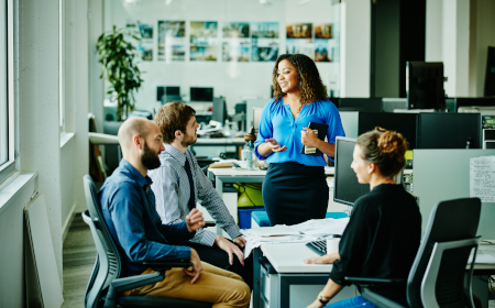 A group of people in a modern looking office having a meeting.
