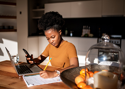 Woman sitting on her laptop calculating her bills