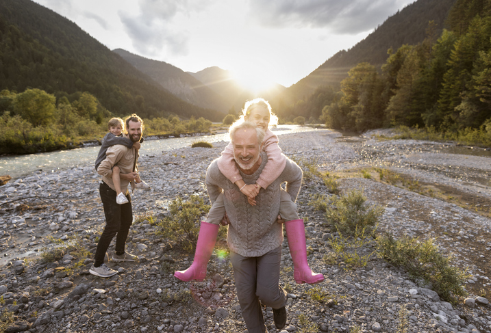 Premier banking customer on holiday, smiling and spending time with his children and grandchildren