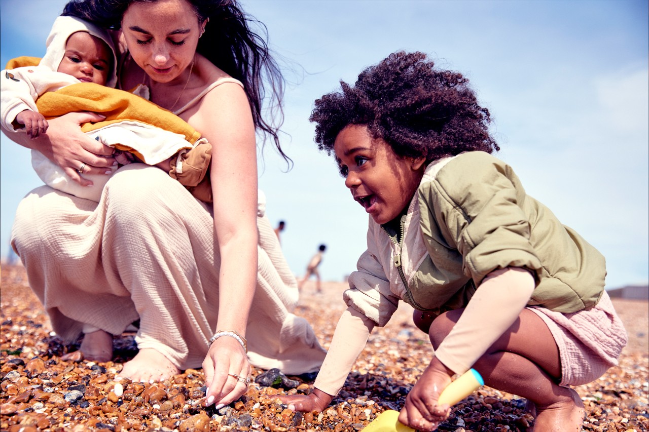 Mum and kids on the beach thinking about NatWest Premier financial planning