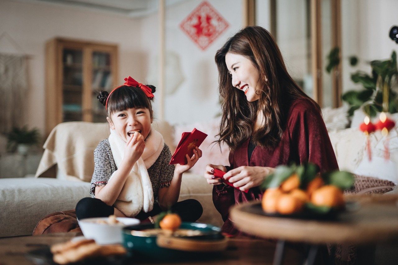 A NatWest Premier financial planning customer plays with her daughter during Chinese new year